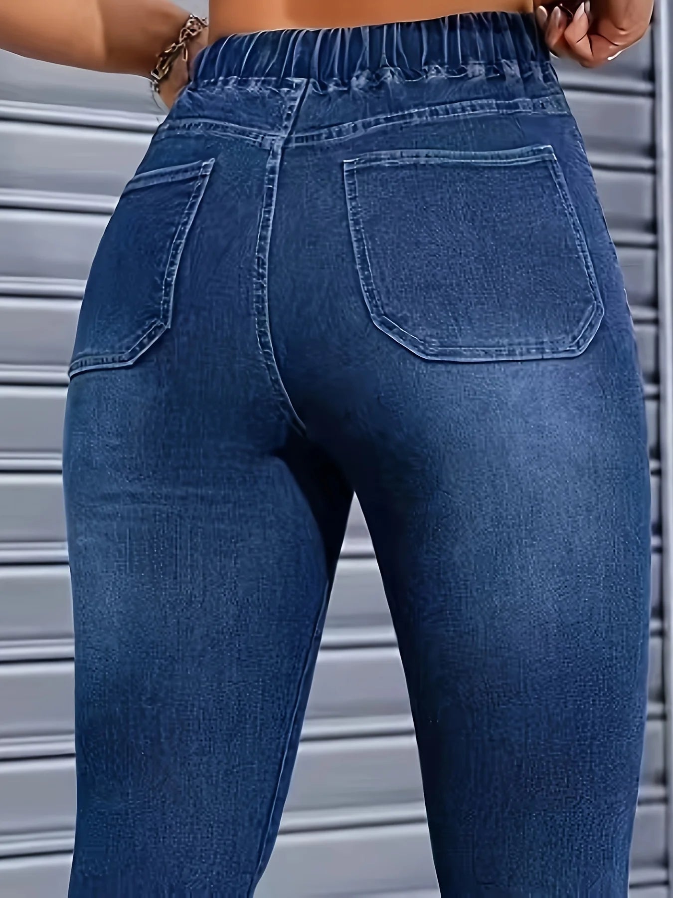 Women's high-waisted skinny jeans with drawstring waist, elastic cuffs, and slimming fit