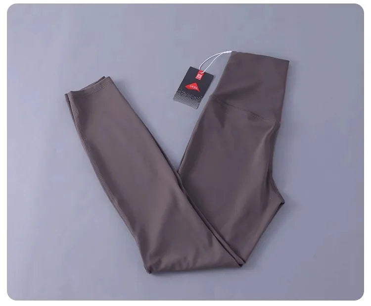 Women's high-waisted yoga pants with sculpting peach lift, buttery soft fabric for running and training.